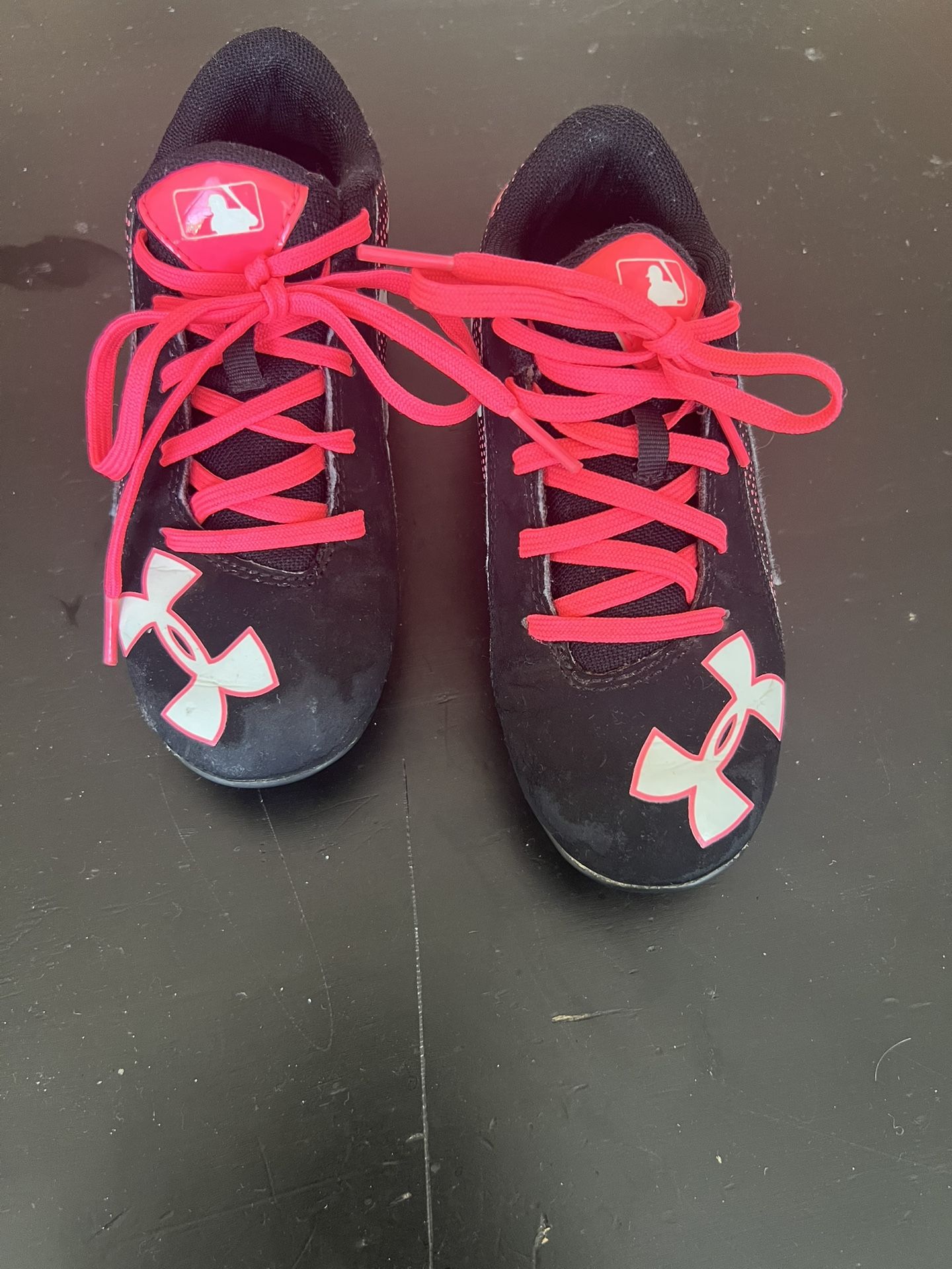 Girls Under Armour Pink/Black Baseball Cleats. Size 12. Used. Good Condition. 
