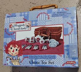Raggedy Ann & Andy Classic 13 Piece China Tea Set packed inside a wicker picnic hamper.