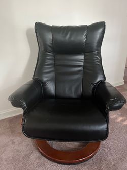 Comfortable black reclining/swivel chair with a wooden base.