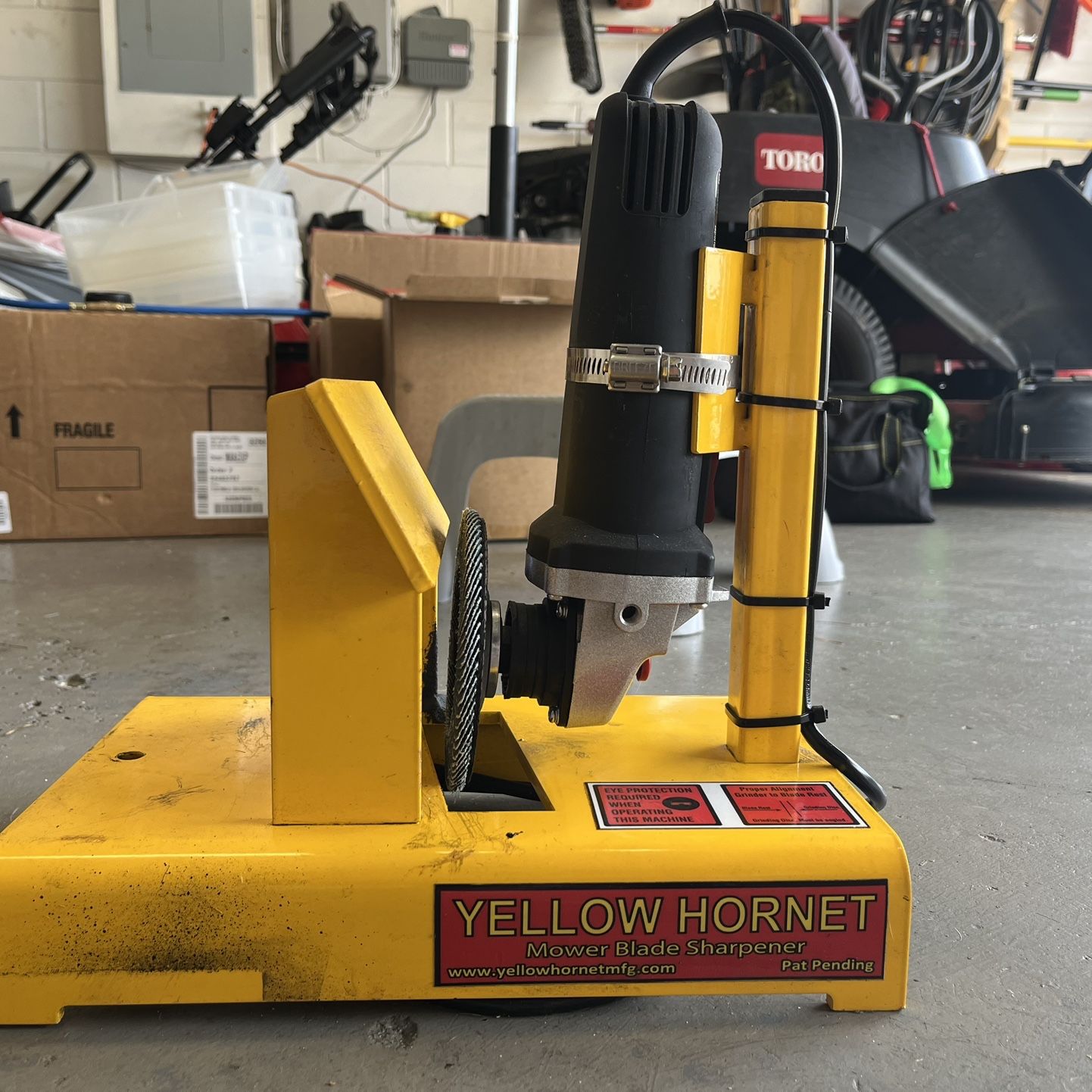 yellow hornet mower blade sharpener including angled grinder for