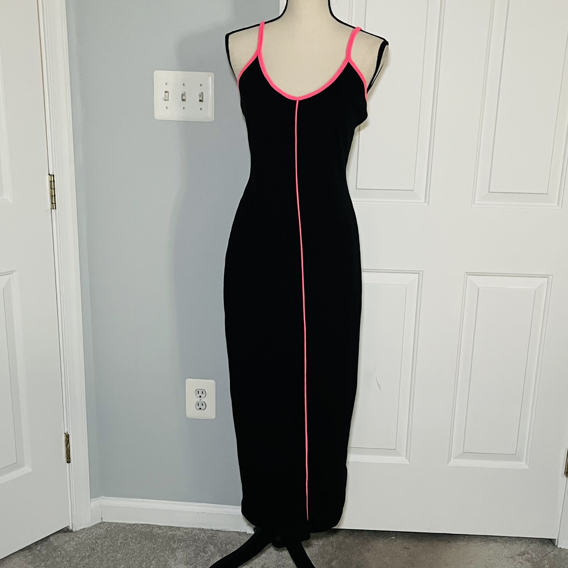 Black midi dress with neon pink accents.  