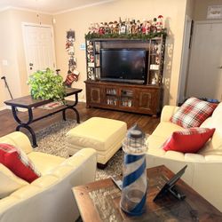 Living Room entertainment center, 3-piece leather sofa, chair & ottoman, a 8x10 area rug. Free 55” TV