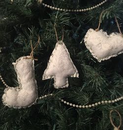 Three hand sewn embroidered linen ornaments...