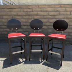 THREE RED AND BLACK STOOLS