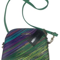 The Steve Madden BMarylin printed crossbody is a stylish and trendy handbag designed for women. The bag features a solid pattern with a zip closure an