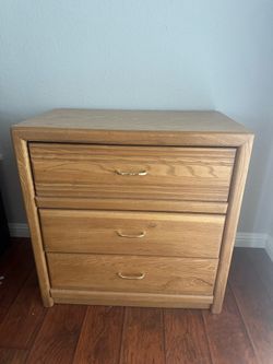 traditional-style oak 3-drawer dresser featuring a light wood grain finish and curved brass-toned handles