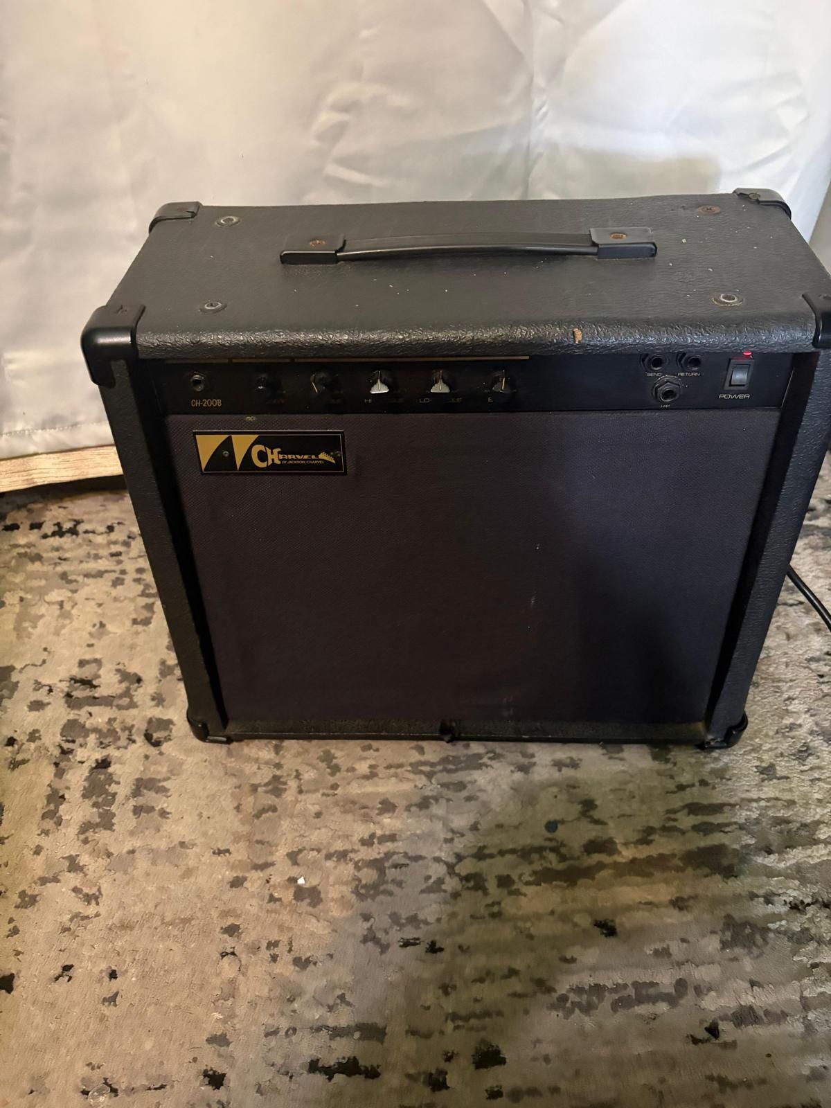 Charvel CH-200B bass amplifier. It is a solid-state combo amp with a 20-watt output and a single 8-inch speaker.  It was manufactured in the early to 