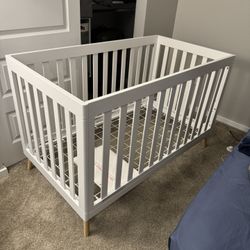 Delta Children Essex 4-in-1 Convertible Baby Crib, Bianca White with Natural Legs