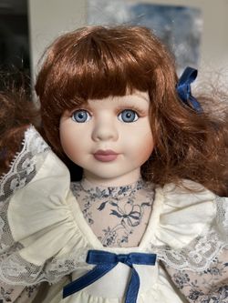 Geppeddo Doll Porcelain 16” Doll auburn hair, blue eyes stand w wooden base  Measurements are approximate.   Non-smoking no pet home. Please see all p