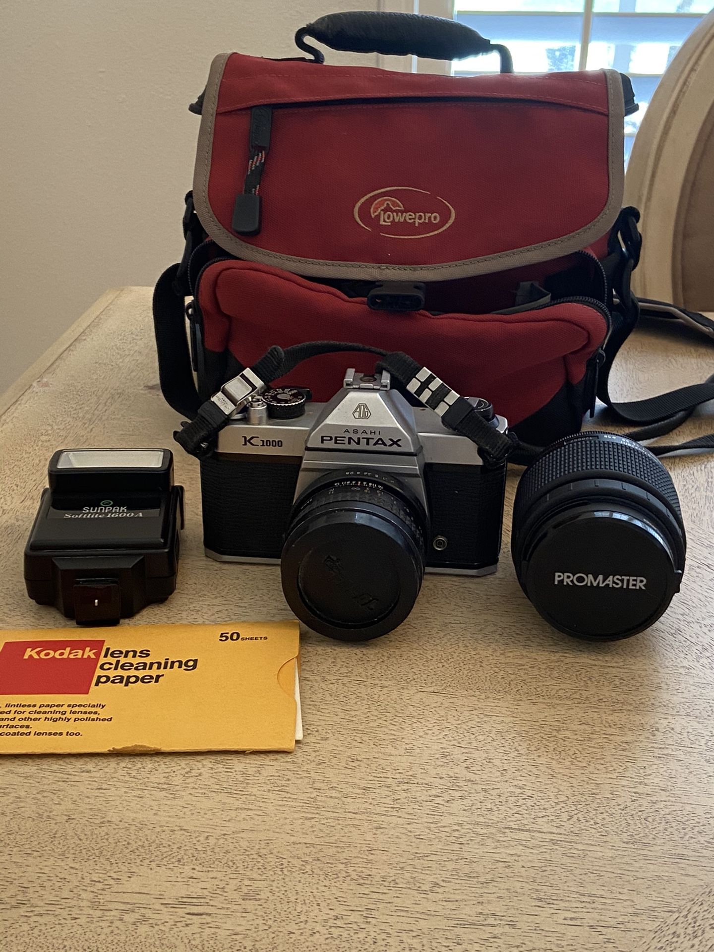 Pentax Asahi - K 1000 Camera w/ Lens, includes: Extra lens - Promaster, Flash SunPass, Case -Lowepro, & cleaning paper. In excellent condition $99