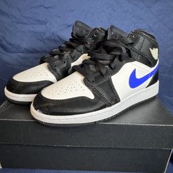 Nike Air Jordan 1 Mid GS in the "Black Racer Blue" colorway. 