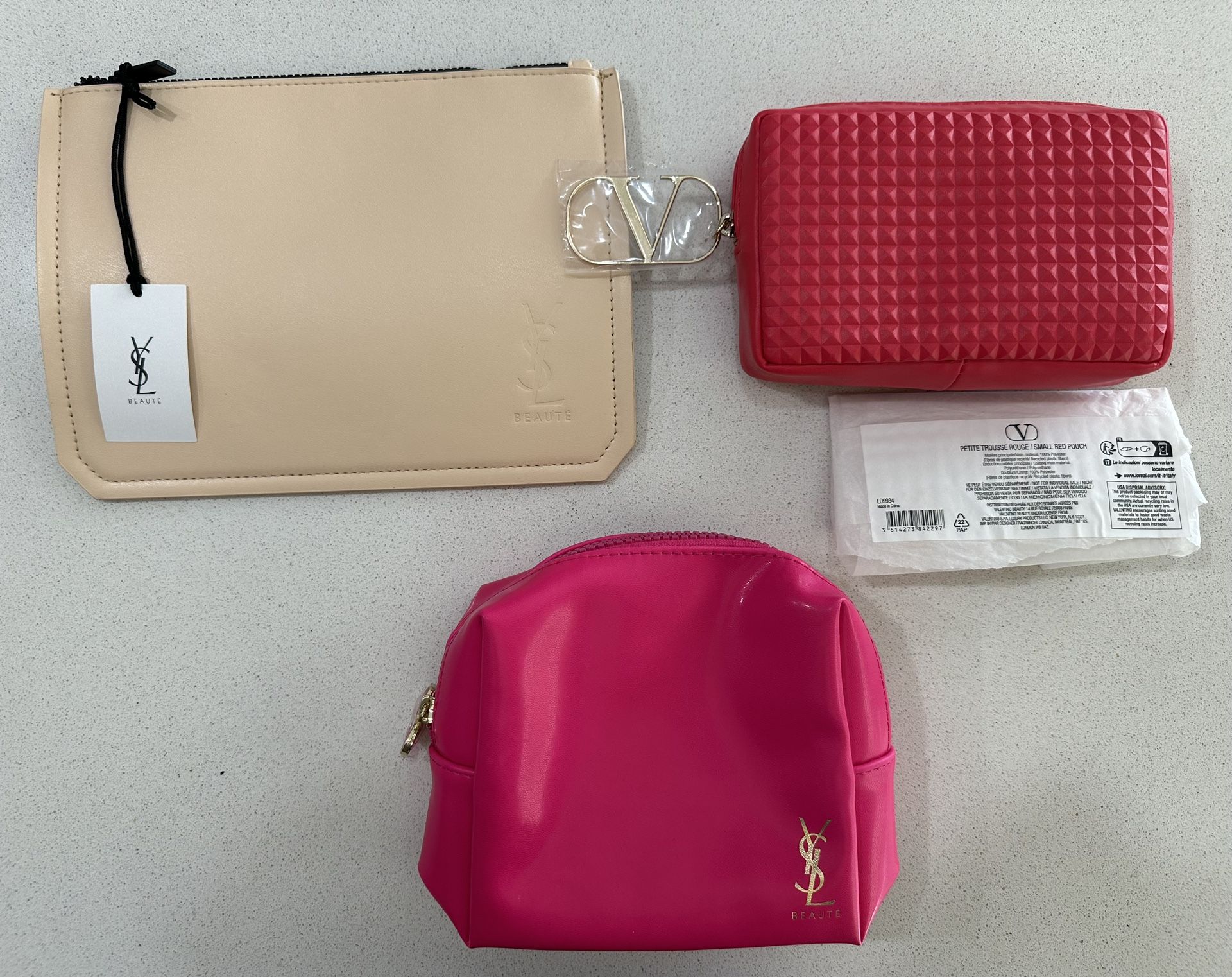 Set of 3 Yves Saint Laurent and Valentino beauty cosmetics bags for girls.