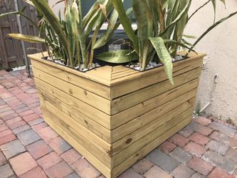 Wood cover for A/C with A flower and plant pot