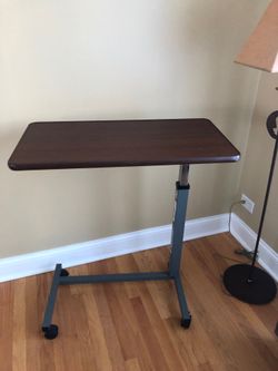 Adjustable over bed bedside table with wheels