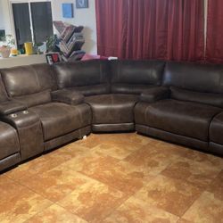 Large leather sectional w/ 4 power recliners and removable wedge.