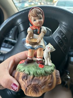 This is a vintage Goebel or Erich Stauffer porcelain figurine of a young girl in a red hooded dress with a kitten.