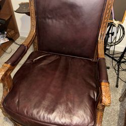 Two Burgundy Leather ornately carved sitting chairs. $1500 OBO