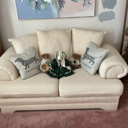 Cream colored sofa and loveseat