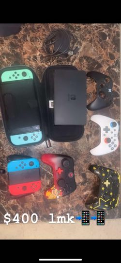 Nintendo Switch bundle with multiple controllers and a carrying case