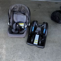 Newborn baby car seat with base.