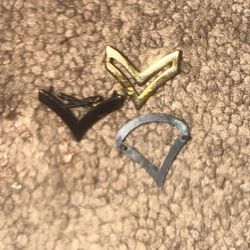 These items are called US Army Private First Class (PFC) collar rank insignia