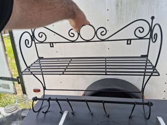 Wall mounted shelf with 6 hooks to hang items.