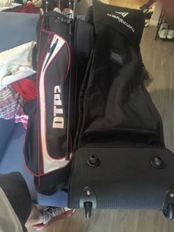 Brand new golf bag with another golf bag full of clubs