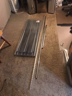 Several various sizes of elfa platinum ventilated shelves from the container store