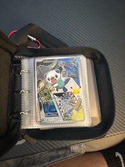 Some rare pokemon cards and a small binder