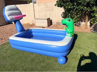 Kids inflatable pool with dinosaur sprinkler and basketball