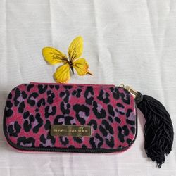 Marc Jacobs "Cat's Meow" cosmetics case, featuring a pink glitter leopard print, a gold-toned logo plaque, and a black tassel zipper pull