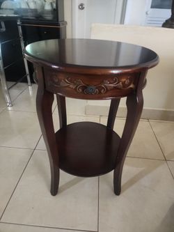 Round table. It's brown  wood.
