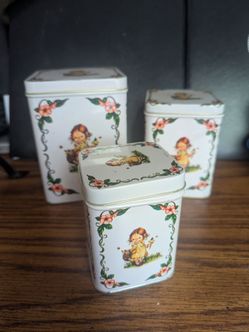 Vintage Metal tins: 3- Layered metal tins with a young girl holding a basket picking flowers.