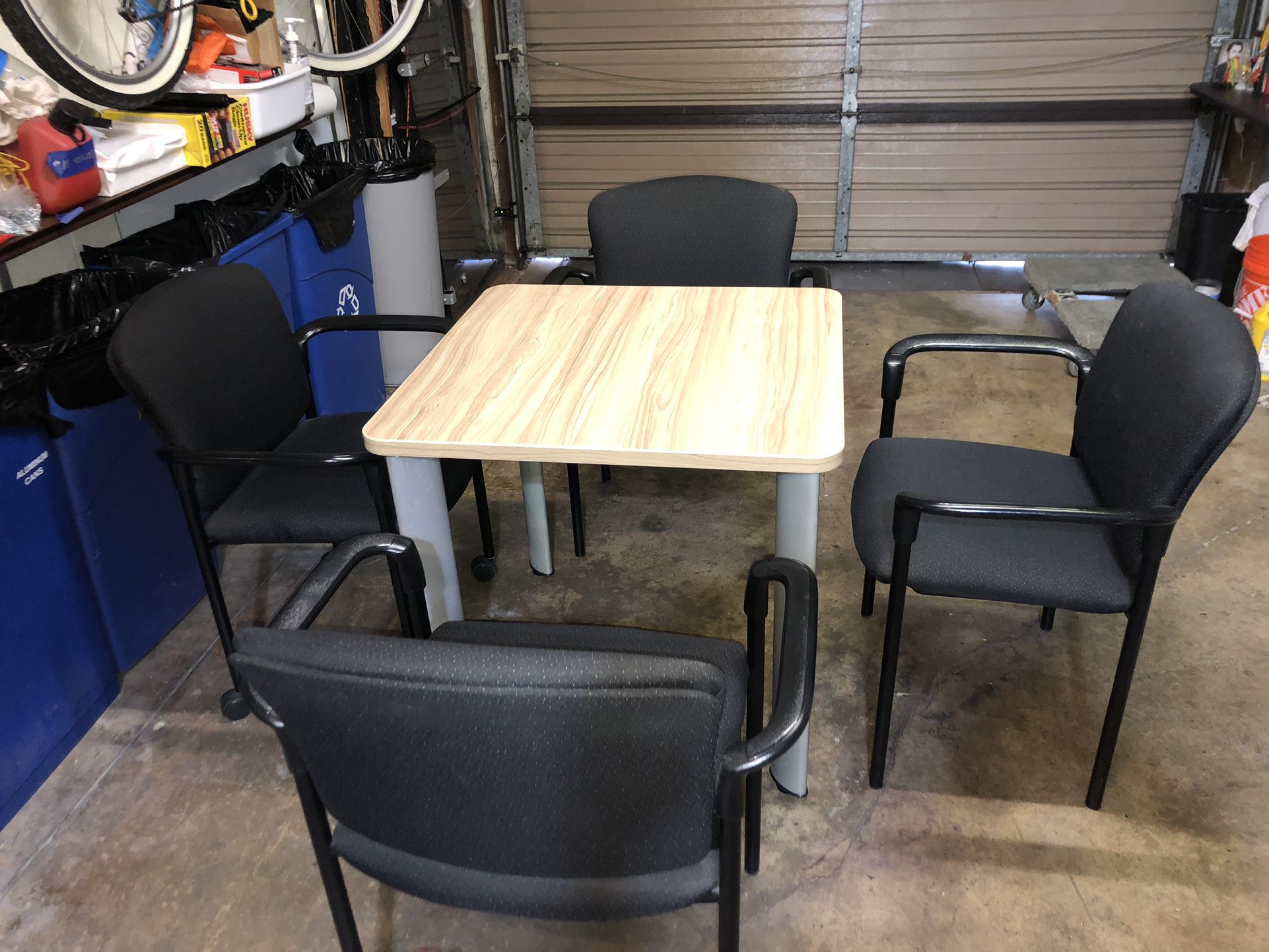 Table With 4 Black Stacking Chairs 