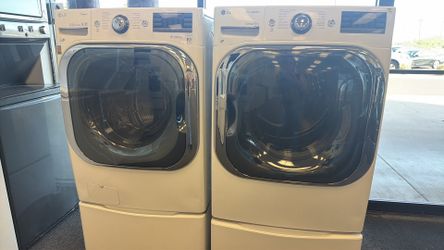ELECTROLUX FRONT LOAD WASHER AND DRYER STACKABLE SET ON PEDASTALS