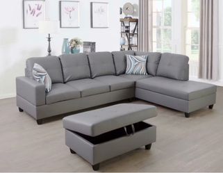 Gray leather sectional couch and ottoman