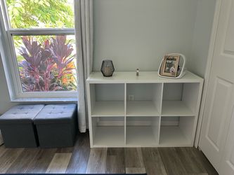 White shelf organizer, end table with inside compartment for dog or cat bed, outdoor chair with foot rest, bookshelf