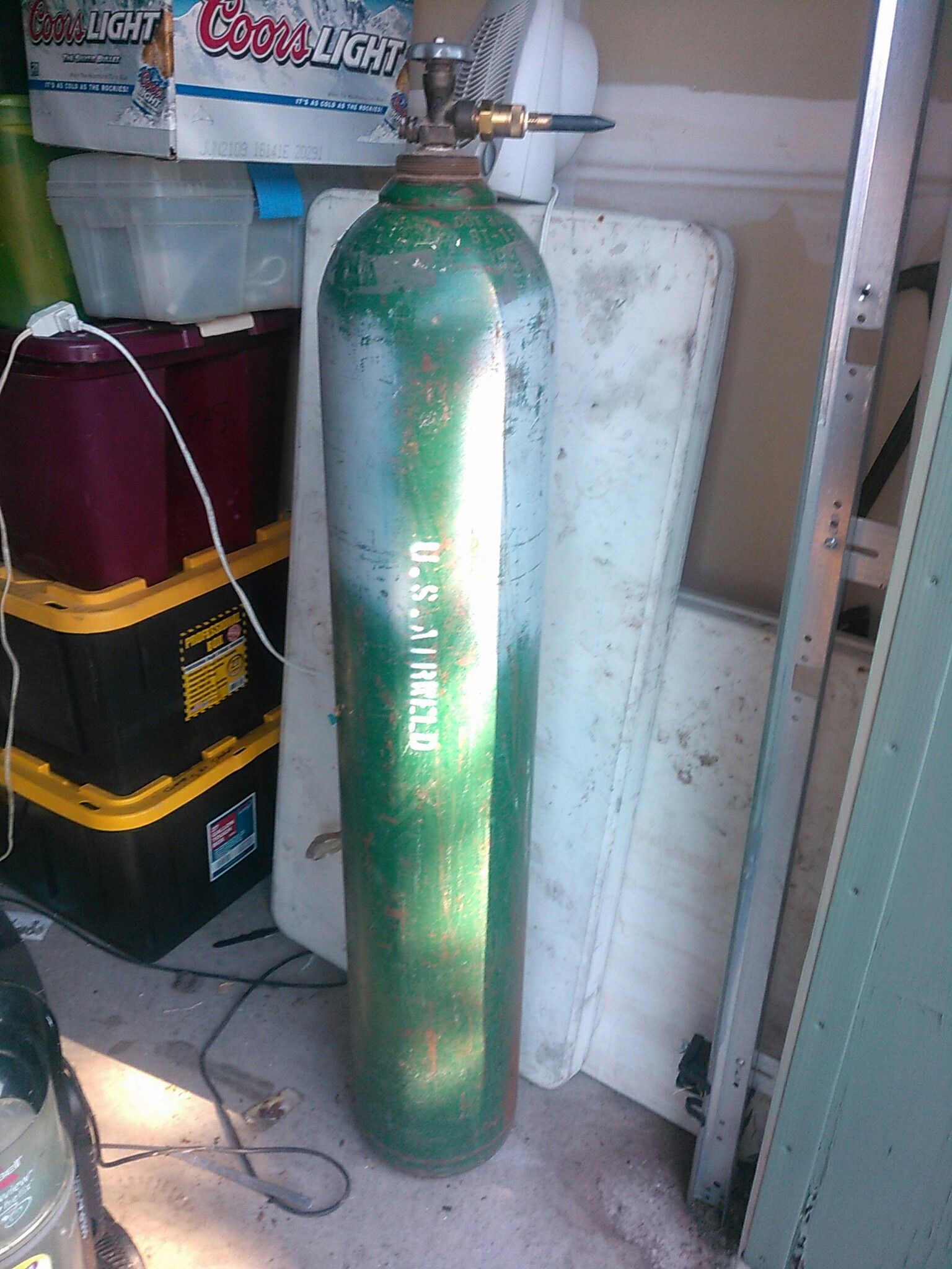 Large commercial size helium tank with nozzle has helium in it