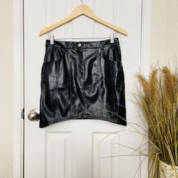 Medium leather skirt has back pockets 