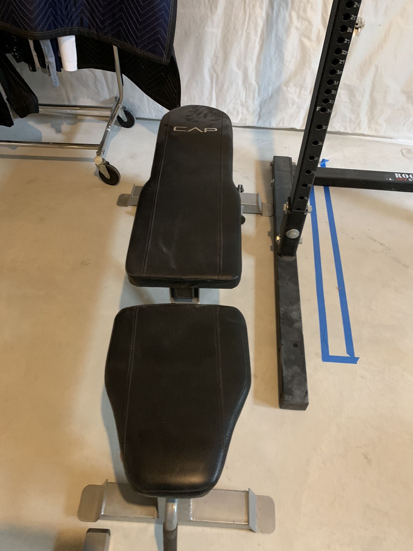 Rogue squat rack with dumbbells up to 80 lbs. bench press rack with bar.. EZ curl bar and triceps bar.. plate rack with dumbbell rack .. used and in