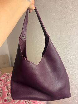 Purple leather tote bag with a boho vibe.