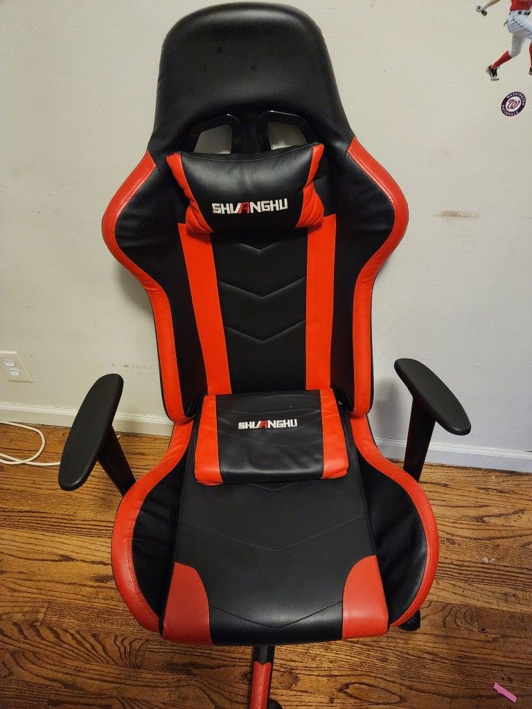 Red and black gaming chair with foot rest