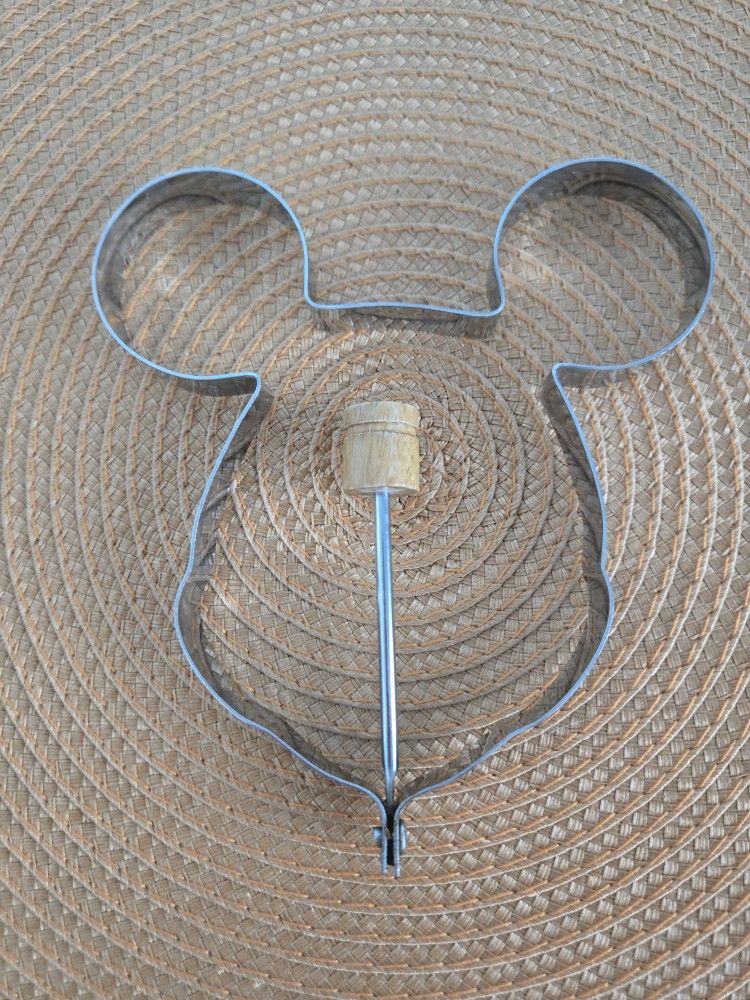 The Mickey Mouse Metal Mold with Handle is a charming and practical kitchen tool perfect for creating Mickey Mouse-shaped pancakes, and eggs.