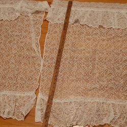 2 lace curtains with ruffled edges and  tie backs