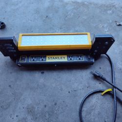 It's A Stanley 1000 Lumens Portable Work Bench Shop Light with AC and 2.1 Amp USB Power Strip Charging Ports 