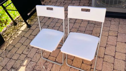 Two IKEA plastic chairs