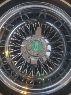 13in chrome cross lace wheel s and tires great condition