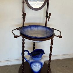 Wooden washstand with blue and white ironstone pitcher and bowl set