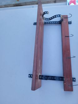Vintage wooden wall-mounted coat and hat rack or wall unit featuring dark wood slats and black metal brackets vintage mid-century approx 8x10x18"