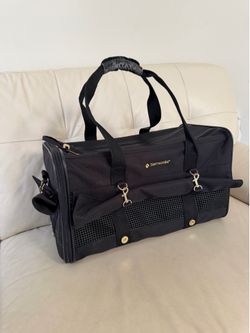 black Samsonite pet carrier featuring gold-toned hardware accents, for small dog or cat